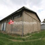 Mekanisa, 6,000 meter square land with 700 meter square warehouses for sale, Addis Ababa.